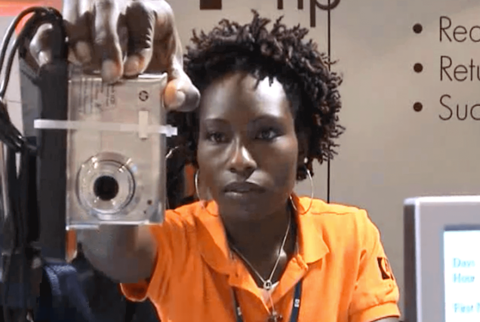 A woman holding a HP camera